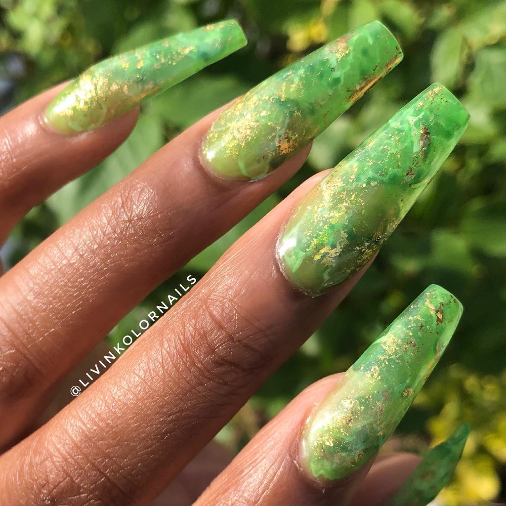 sheer green jelly and marble coffin nails. Gold flakes in between.