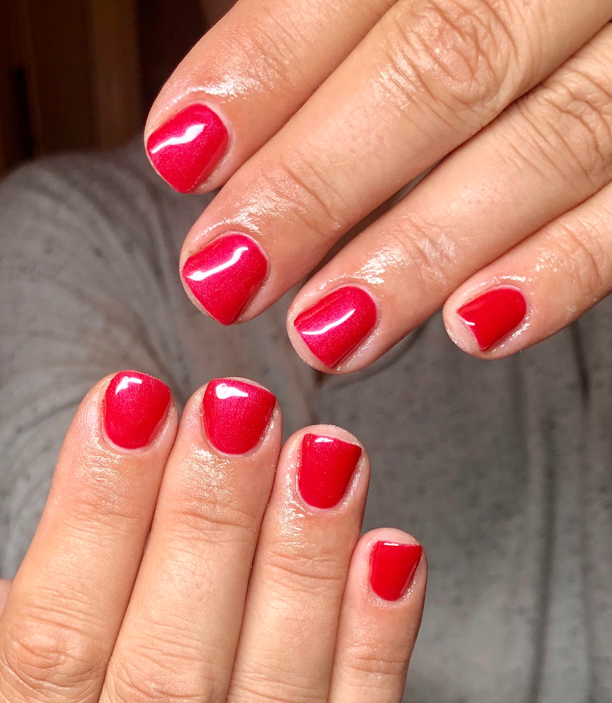 red gel shimmer nail polish on natural nails