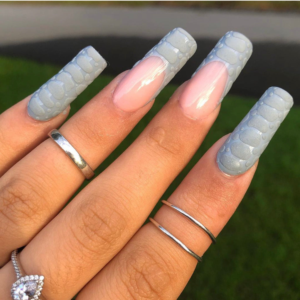 grey gel nail polish with matte and glossy top coat. French manicure and christmas sweater nail design. Silver knuckle rings. 