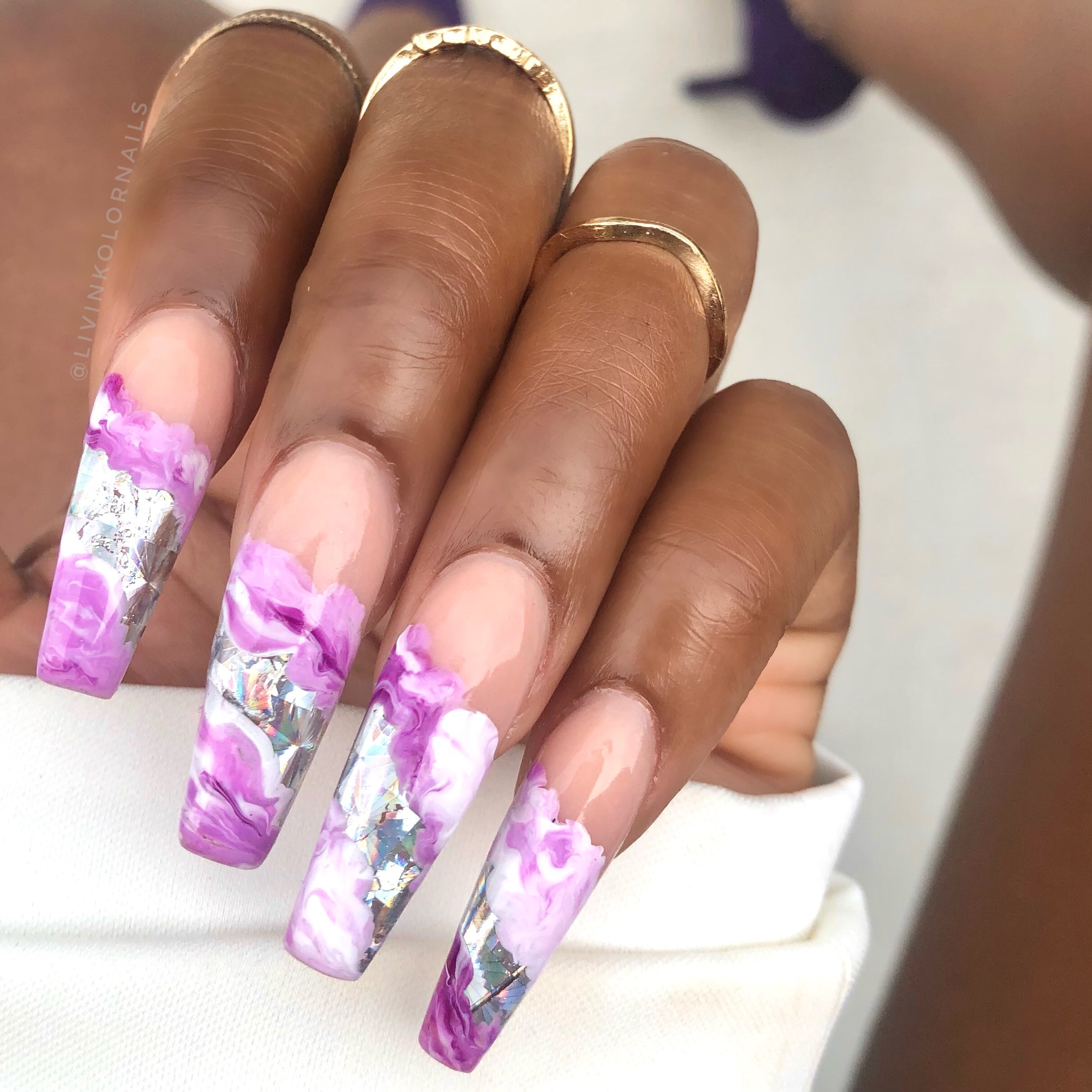 Purple marble nails with gel polish. Colors used are dark purple, white, and lavender purple